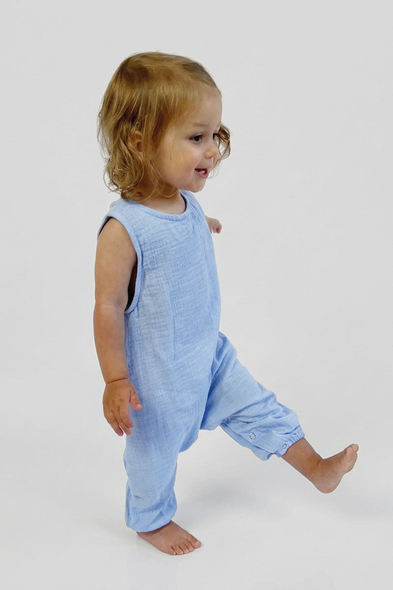 Child wearing a light blue sleeveless romper on a white background