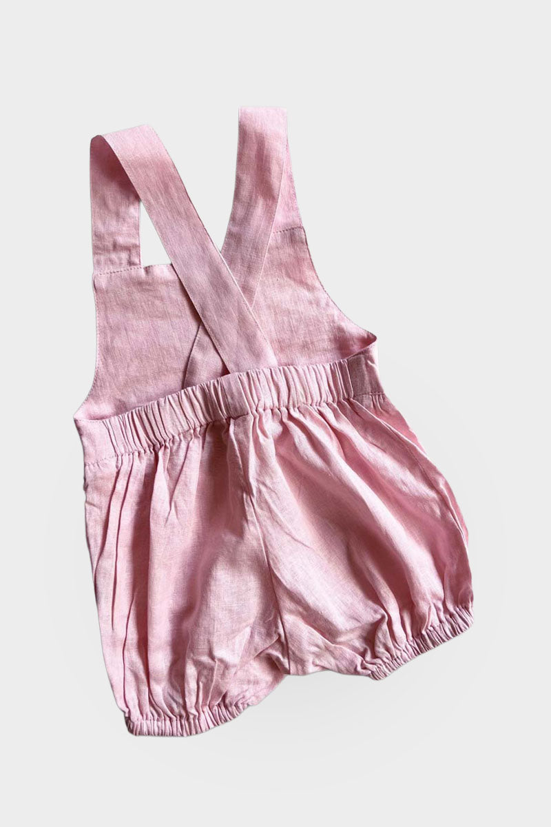 Back of light pink overalls on a light grey background