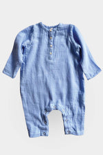 Long sleeve blue jumpsuit on grey background