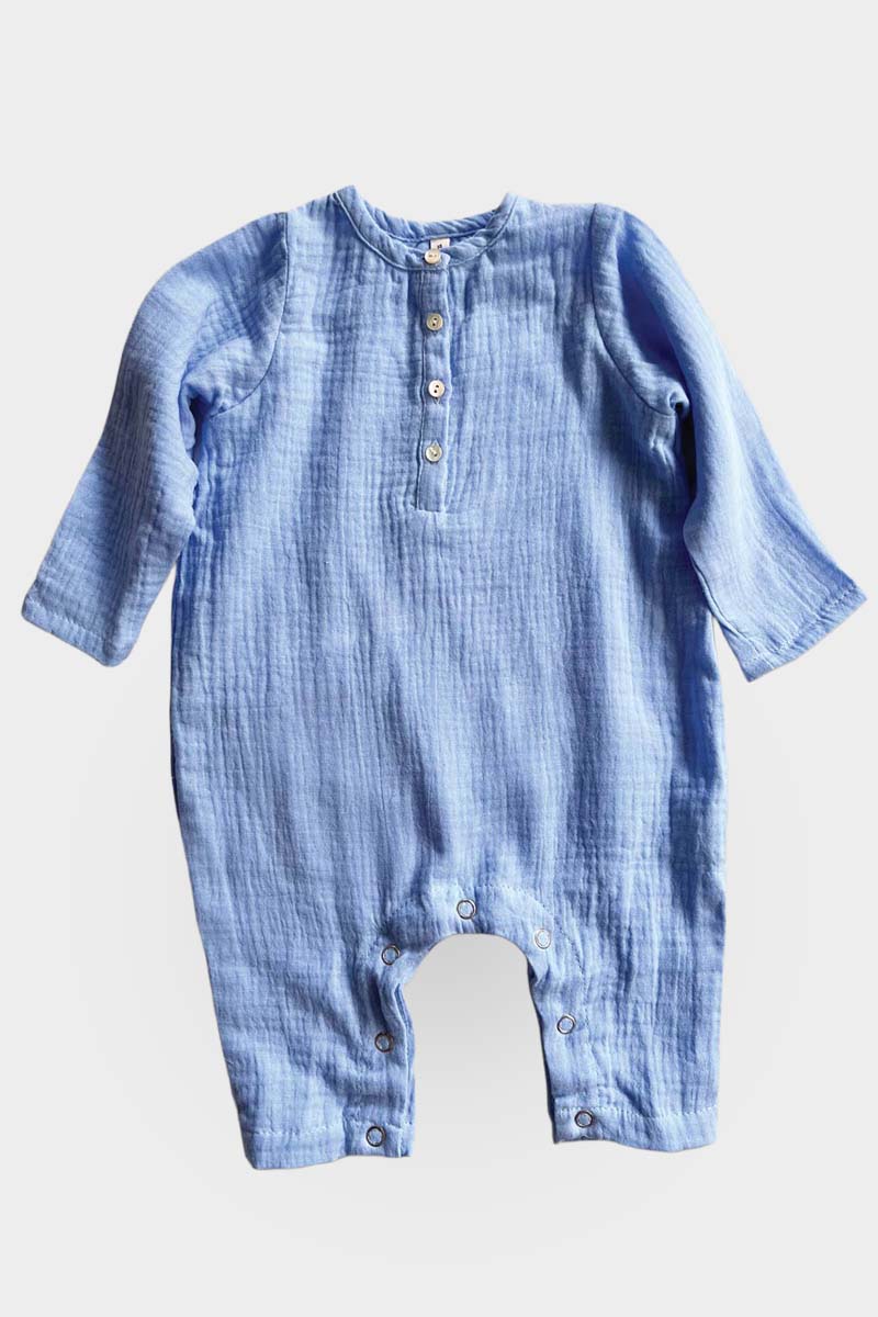 Long sleeve blue jumpsuit on grey background