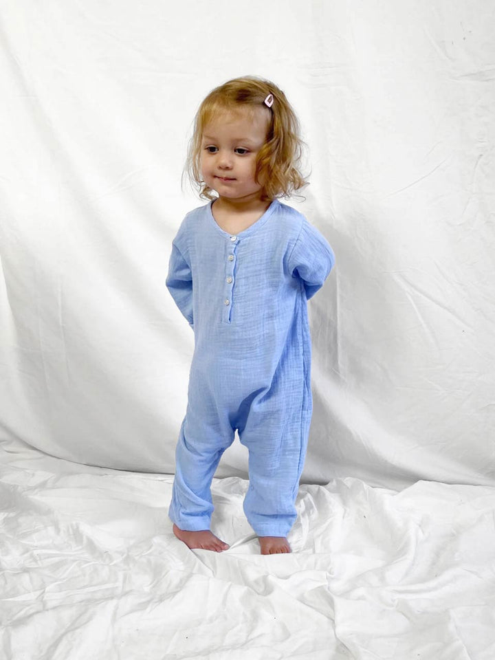 Blue baby jumpsuit with long sleeves modelled front view