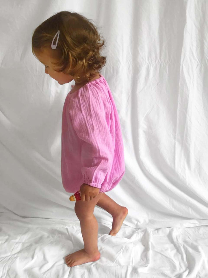 Romper with long sleeves in pink modelled side view