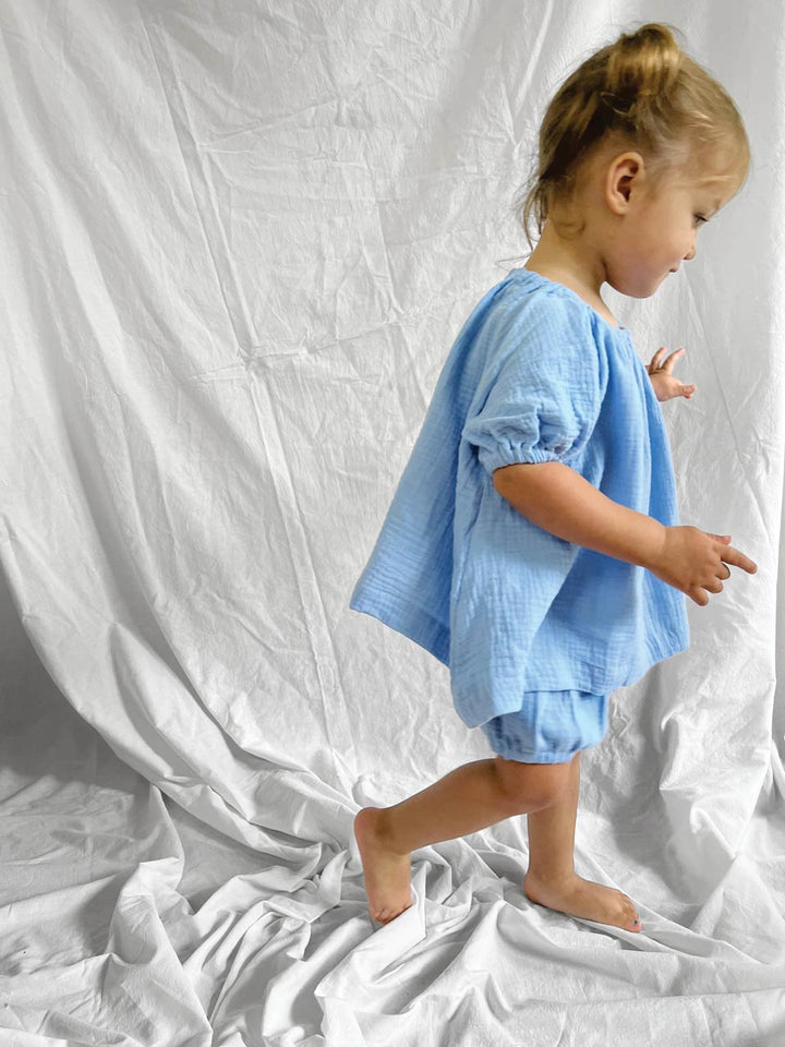 Blue short sleeve top and bloomers modelled side view