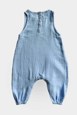 Blue baby jumpsuit with buttons on a light grey background
