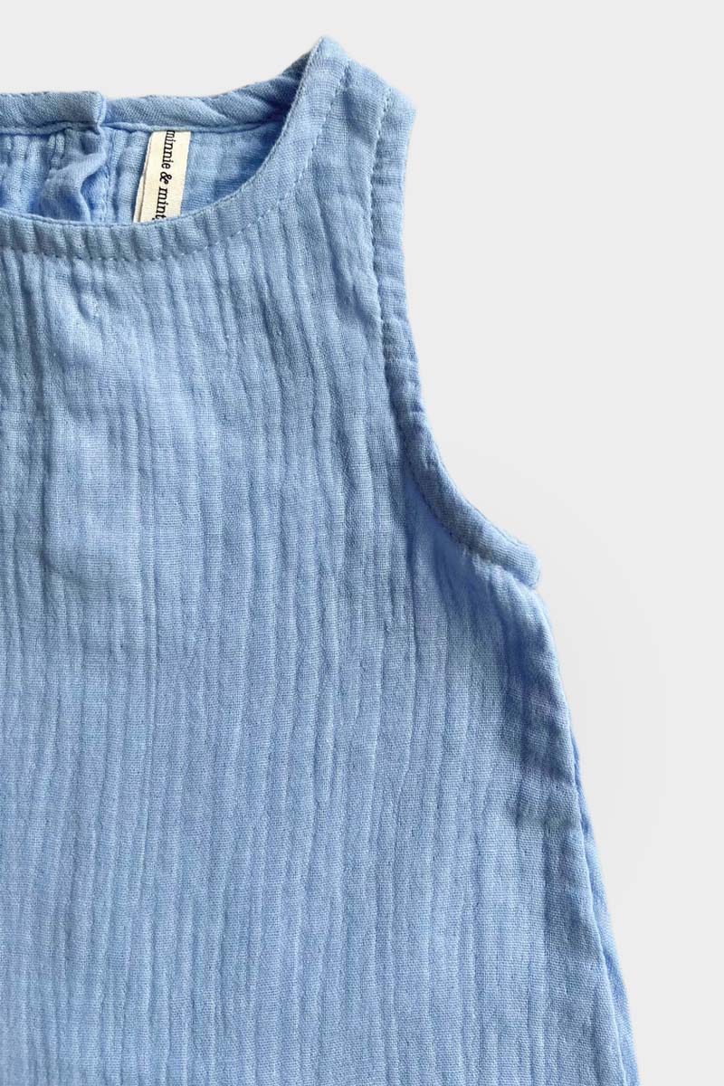 Light blue sleeveless baby jumpsuit on a grey background