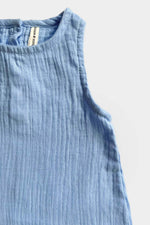 Light blue sleeveless baby jumpsuit on a grey background
