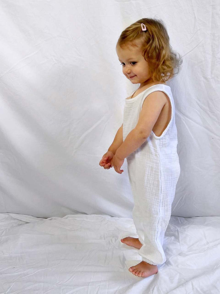 Baby jumpsuit sleeveless in white modelled side view