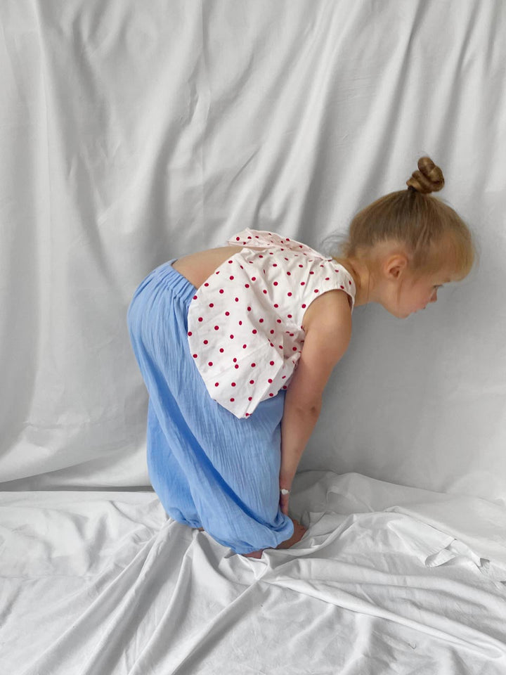 Red polka dot top with open back modelled side view