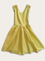 Yellow pinafore dress front on a white background