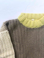 Close up Image of the neck and shoulder of our Anytime Knit in Desert colour on a white background