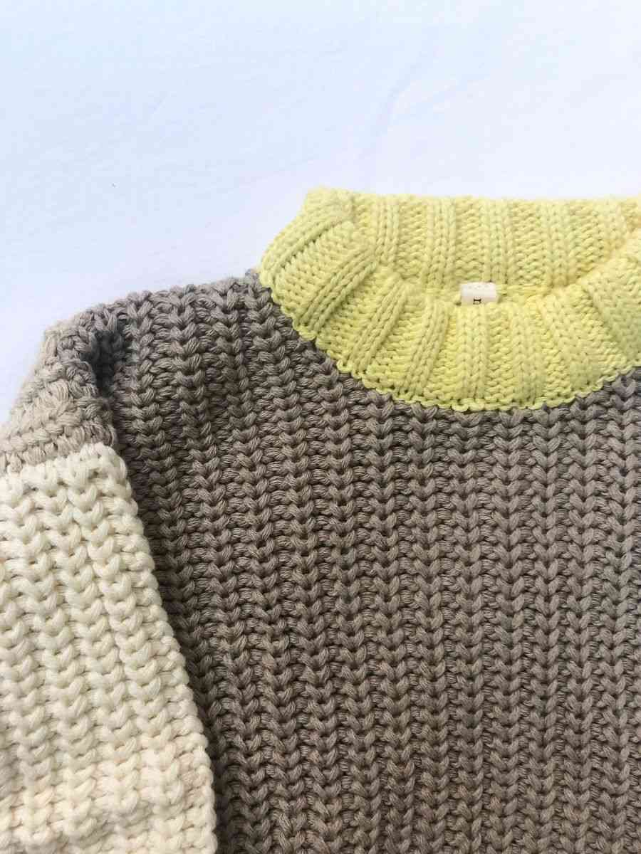 Close up Image of the neck and shoulder of our Anytime Knit in Desert colour on a white background
