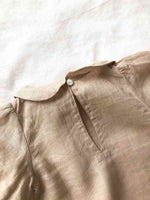 Close up shot of the neck of our Bubble Sleeve Linen Set in Powder Pink colour on a white background