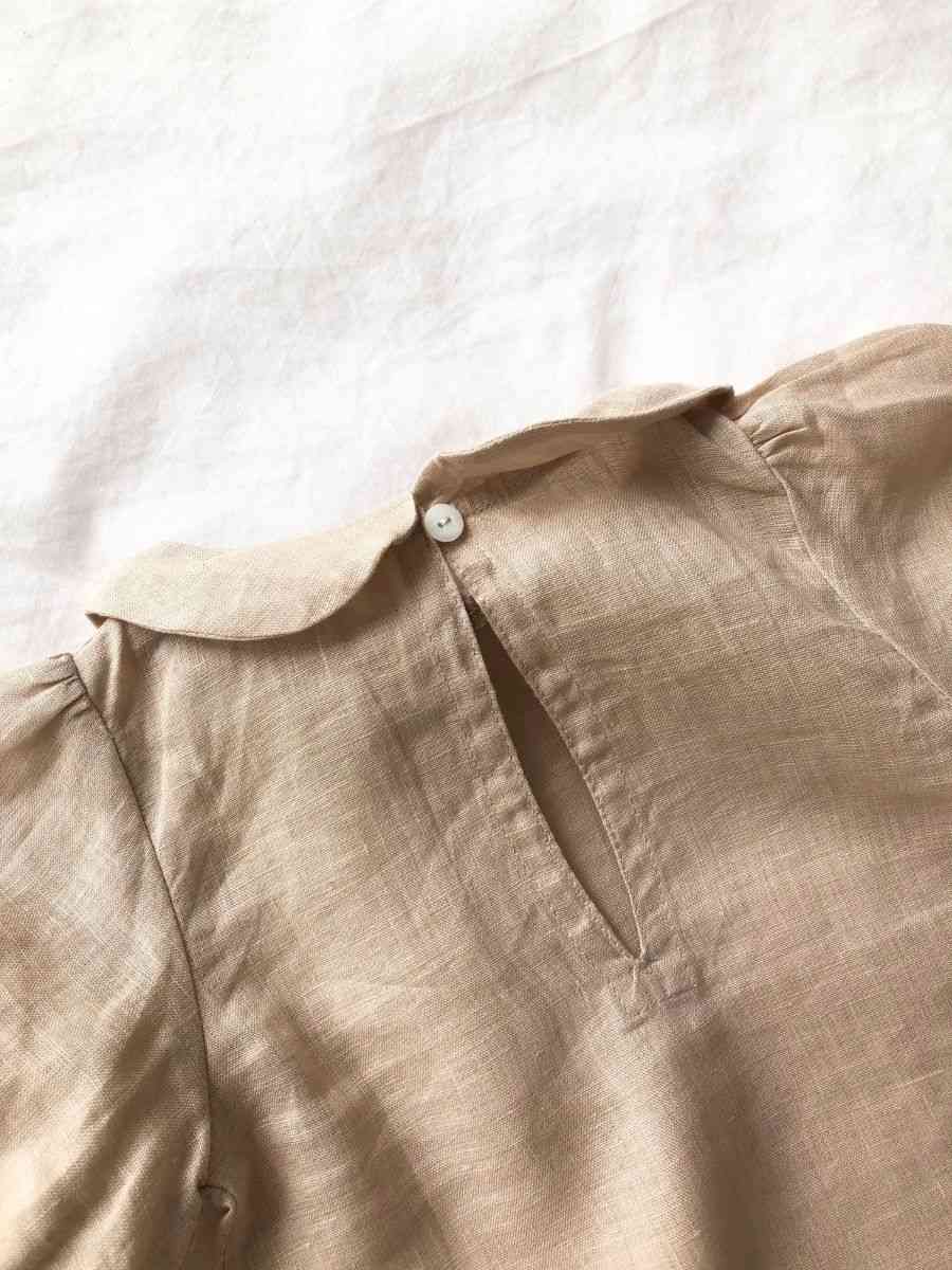 Close up shot of the neck of our Bubble Sleeve Linen Set in Powder Pink colour on a white background