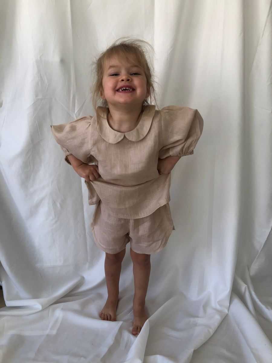 Young girl smiling wearing our Bubble Sleeve Linen Set in Powder Pink colour