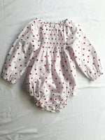 Romper smocked with long sleeves in red polka dot front view