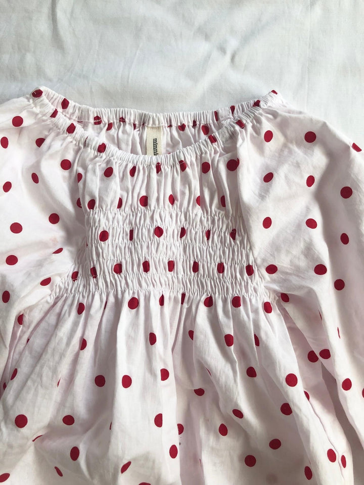 Romper smocked with long sleeves in red polka dot front view 2