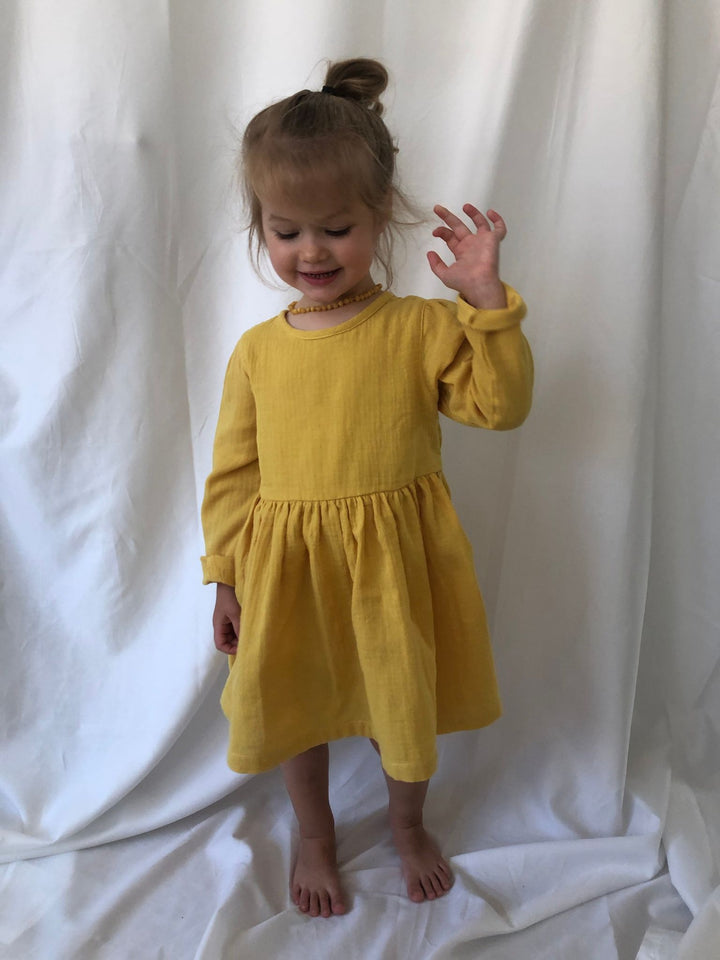 Yellow long sleeve dress modelled